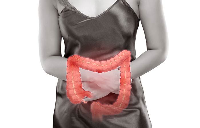 a women pressing her stomach due to dirrhoea 