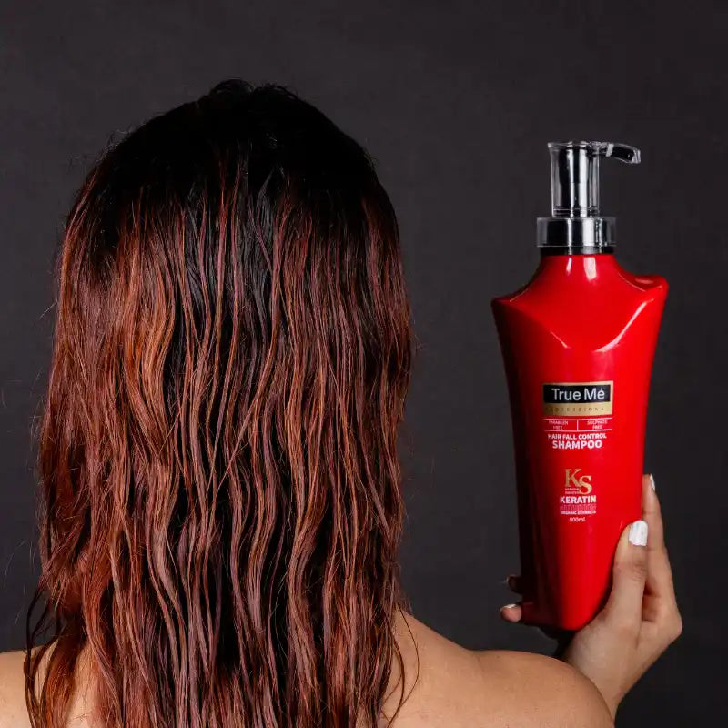 Close-up of a woman applying hair fall control shampoo