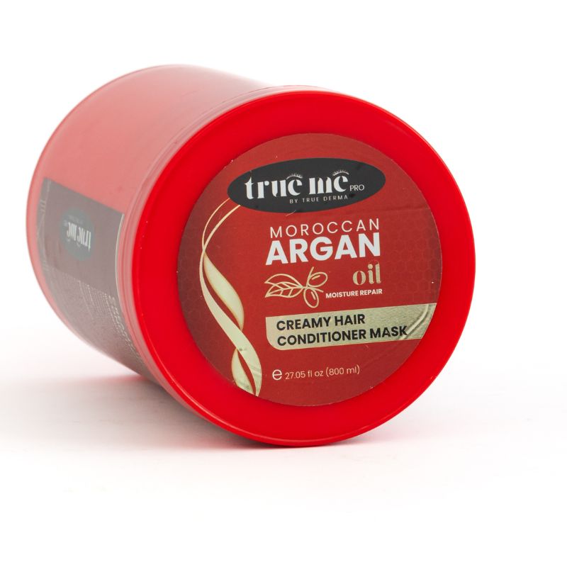A red container of True Me Moroccan Argain Oil creamy hair mask with the brand name and product details displayed on the label.