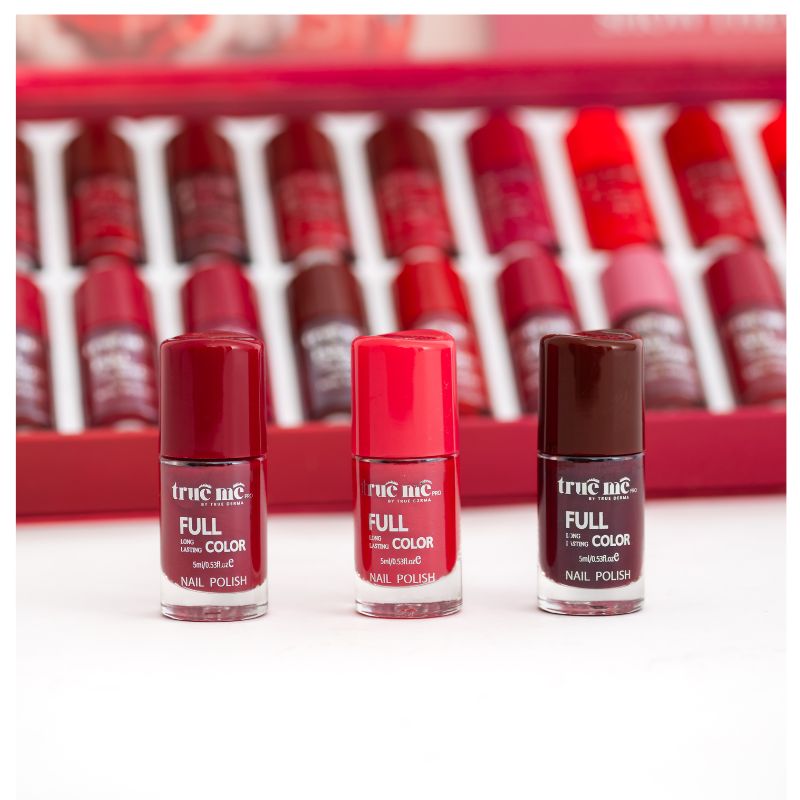 A set of 3 nail polishes in a line, with the bottle tips showing the color of each polish, from left to right:  maroon, red and brown.