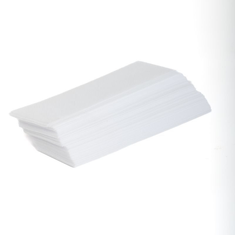 A stack of white non-woven waxing strips against a white background.